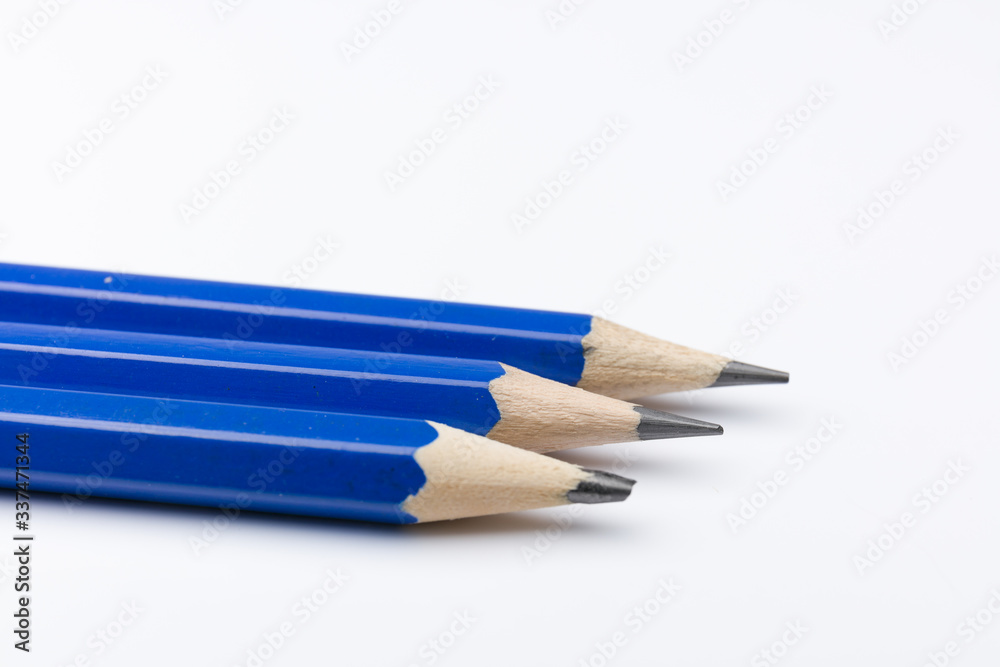 Obraz premium Three blue pencils on a white background