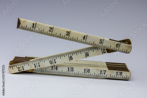 Antique folding ruler on white background