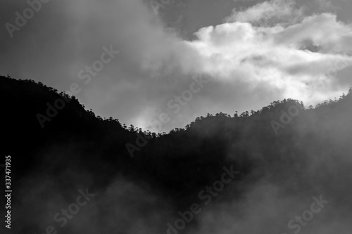 a beautiful mountain view with fog and clouds