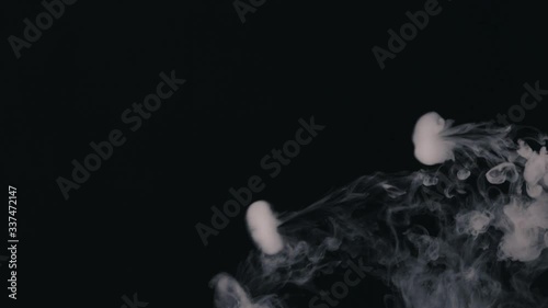 exhales smoke and smoke slowly falls down