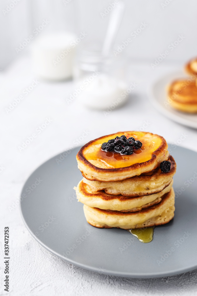 Pancakes. Stack of pancakes with honey on a gray background. Homemade breakfast Pancakes. Stack of pancakes with honey on a gray background. Homemade breakfast