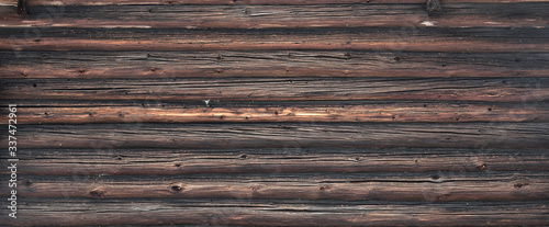 Brown old log wall. Wooden decrepit texture