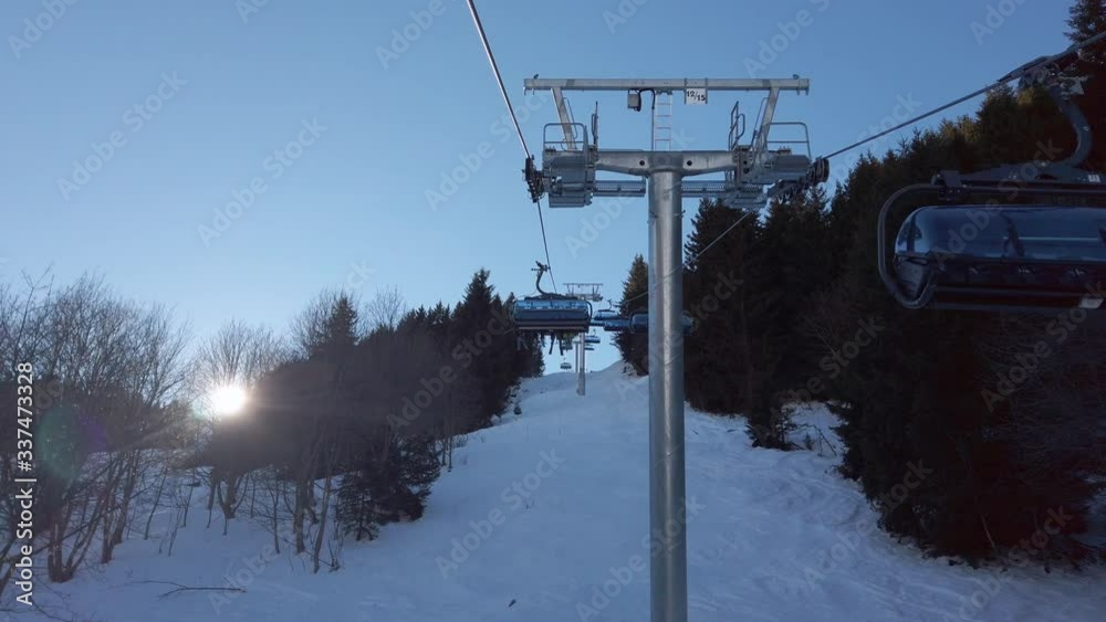 View from a Chairlift on the beautiful winter mountains in a bright sunny day. Val Thorens in the French Alps. View from a Chairlift on the beautiful winter mountains in a bright sunny day. Val Thorens in the French Alps.
