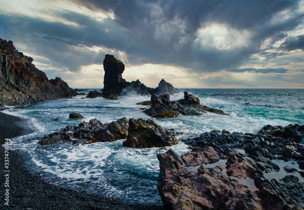 Dramatic shot of stormy coastline with black rocks and high waves on Snaefellsnes peninsula Iceland - obrazy, fototapety, plakaty 