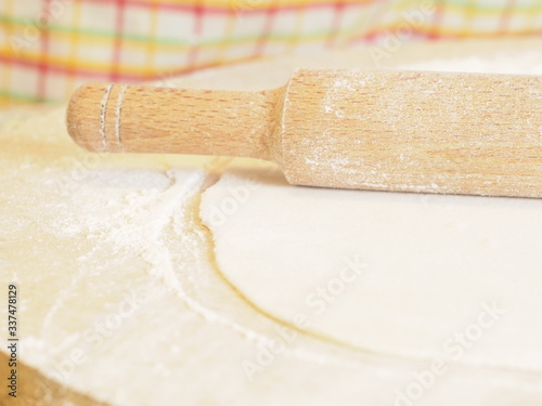 preparation and rolling of dough made of flour. Dough rolled out with a rolling pin by hand
