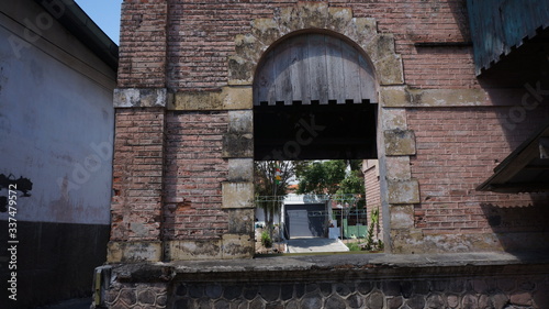 a window from an old abandoned station building in the town of Parakan, Central Java, Indonesia photo