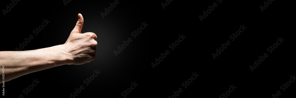 men's hand with thumb up isolated over black