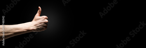 men's hand with thumb up isolated over black