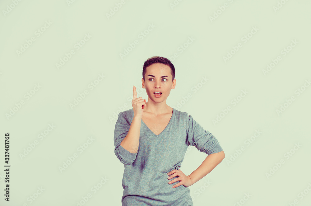 advertisement concept. Attractive young woman in casual clothes pointing her finger up has an idea
