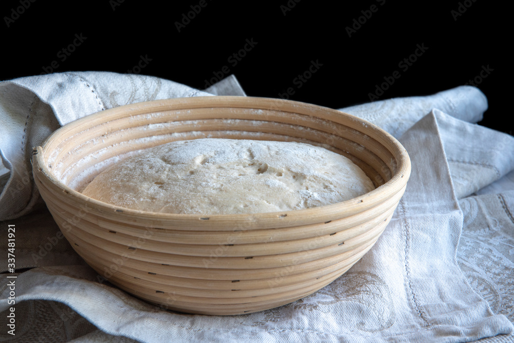 Bread dough rising in basket, home made Bread dough rising in basket, home made
