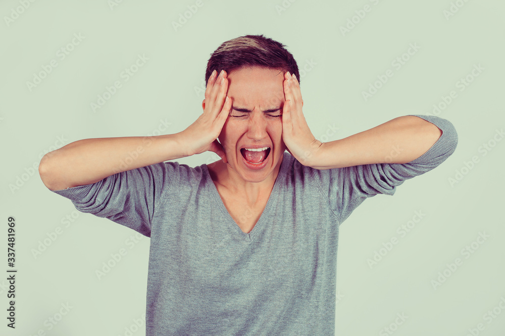 Stressed angry woman yelling screaming has temper tantrum isolated light green gray background. Negative human emotion facial expression reaction attitude Stressed angry woman yelling screaming has temper tantrum isolated light green gray background. Negative human emotion facial expression reaction attitude
