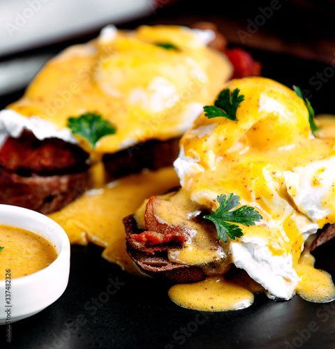 bread slices with becon and cheese sauce on top photo