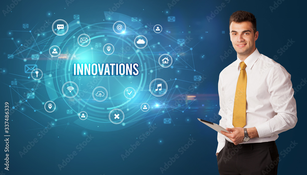 Businessman thinking in front of technology related icons and INNOVATIONS inscription, modern technology concept Businessman thinking in front of technology related icons and INNOVATIONS inscription, modern technology concept