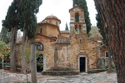 Ruins of ancient monastery of Kesariani in mountains near Athens, Greece photo