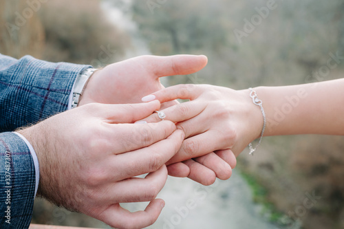 Hand of girl wearing engagement ring