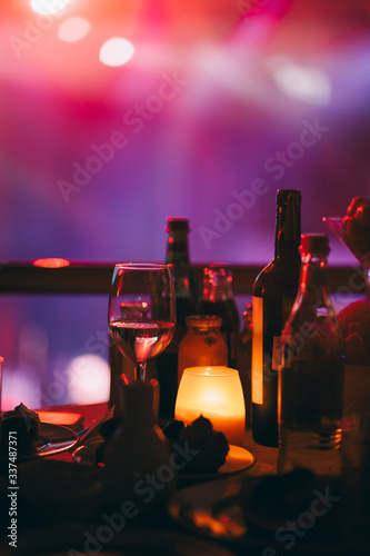 Obraz na płótnie Romantic night in restaurant with wine glass and different types of alcohol drinks w salonie