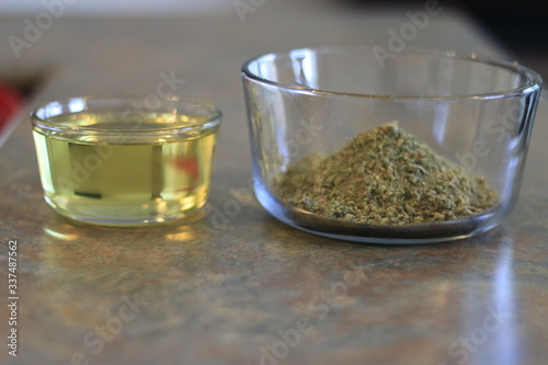 Ground cannabis next to olive oil
