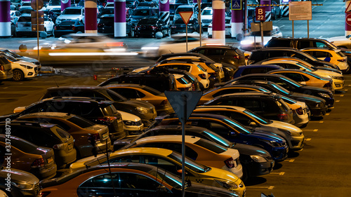 Cars in the Parking lot of a shopping Mall on a night of high sales