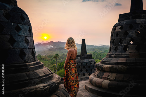 young woman watching sunset at borobudur indonesia