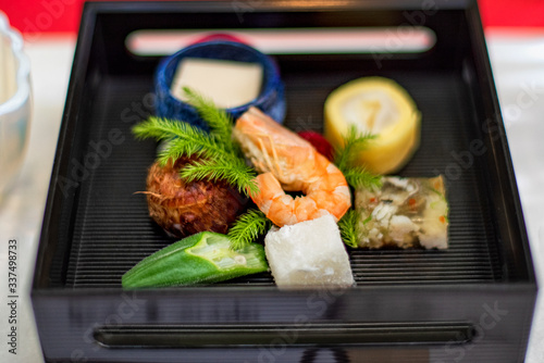 Japanese dish sashimi in a black plateclose up of sashimi sushi set . photo