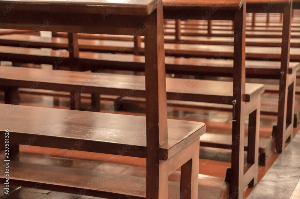 Detail of wooden benches inside a church Detail of wooden benches inside a church