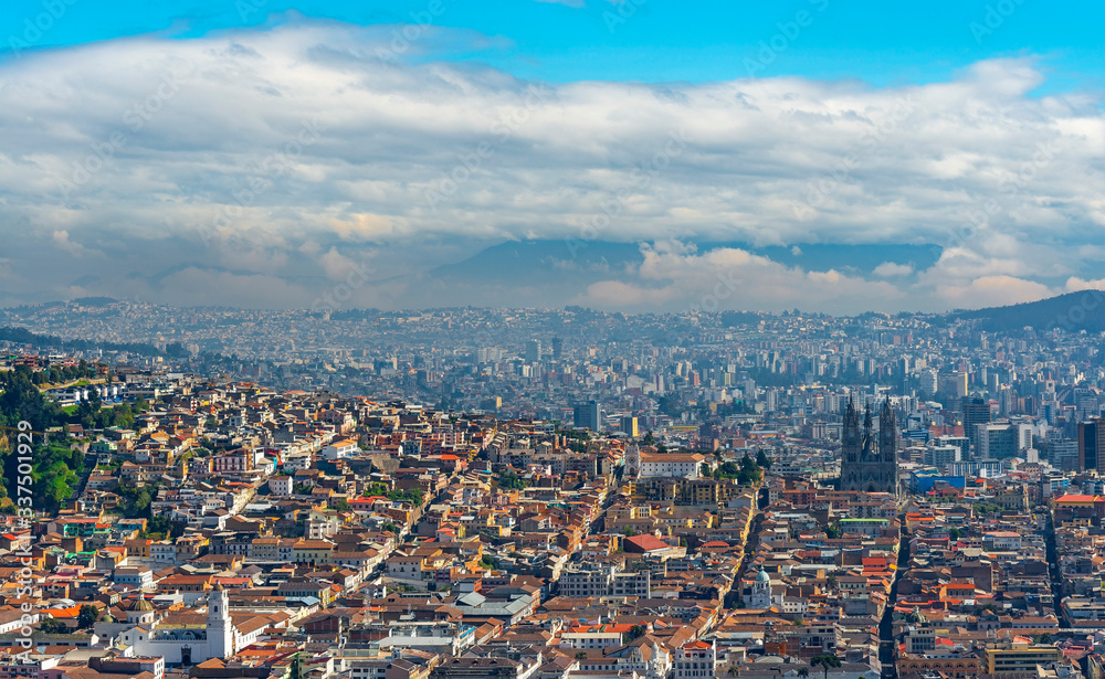 Aerial Panorama of Quito City with the historic city center in the foreground and the modern skyscrapers in the background, Ecuador.