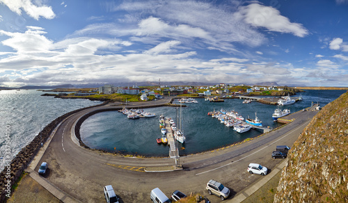 Beautiful panoramic view of the Stykkisholmskirkja Harbor with Fishing ships (boats) at Stykkisholmur town in western Iceland. City view from Sugandisey Cliff with lighthouse. Famous colorful houses photo