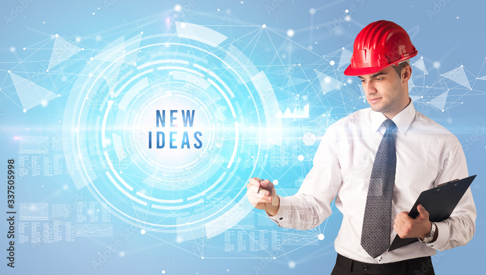 Handsome businessman with helmet drawing NEW IDEAS inscription, contruction business concept Handsome businessman with helmet drawing NEW IDEAS inscription, contruction business concept