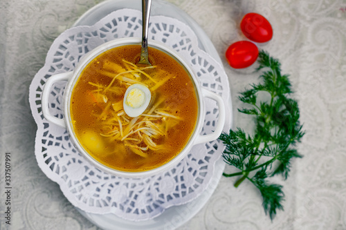 chicken soup with noodles and eggs with vegetables serving for lunch