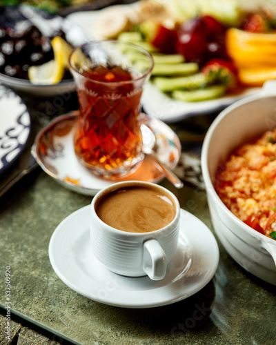 fried eggs with tomato and herbs with black tea and coffee