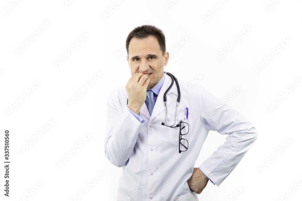 Middle aged worried doctor in white coat and stethoscope looking annoyed and frustrated, nervously nibbling bitting nails because of problems, isolated white background Middle aged worried doctor in white coat and stethoscope looking annoyed and frustrated, nervously nibbling bitting nails because of problems, isolated white background
