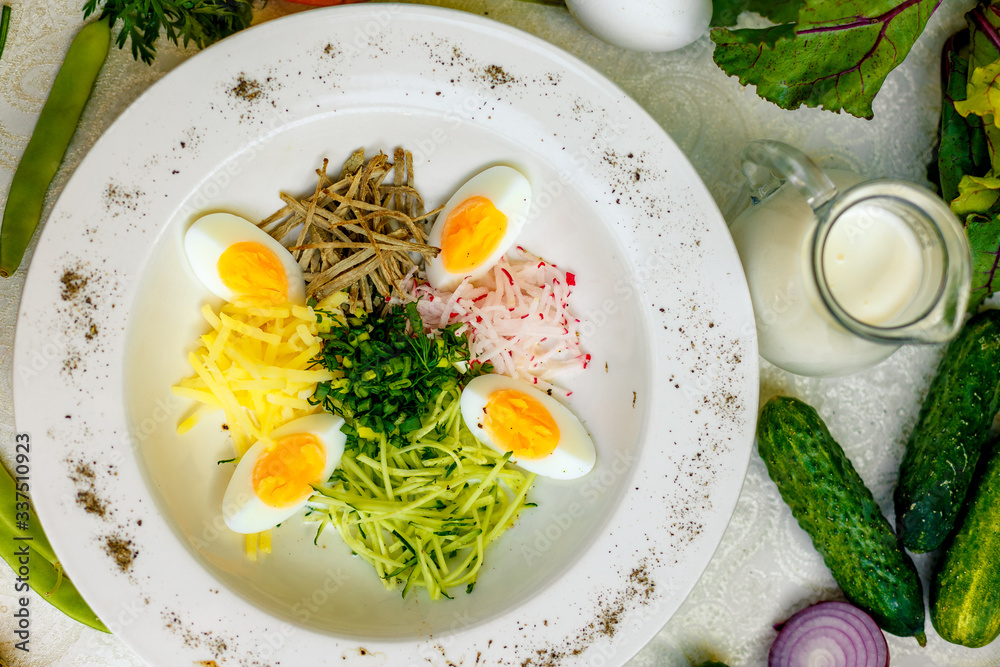 Vegetarian salad with onion radish and egg on a white plate Vegetarian salad with onion radish and egg on a white plate