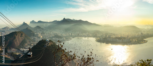 Aerial panorama of Guanabara Bay, statue of Christ the Redeemer and Sugar Loaf Mountain at sunset, Rio de Janeiro, Brazil.