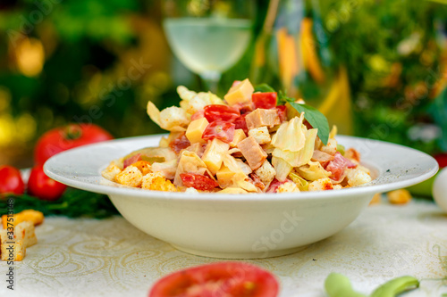 fresh salad with chicken, cheese, rusks, lettuce and tomatoes