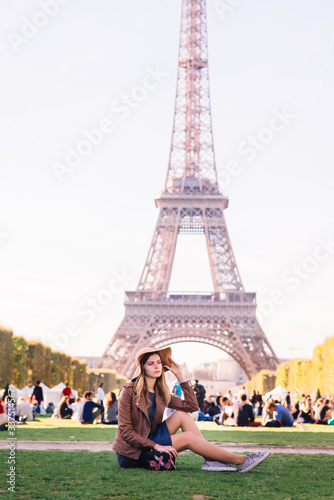 girl sitting in Paris against the backdrop of the Eiffel tower © Aleksei Zakharov
