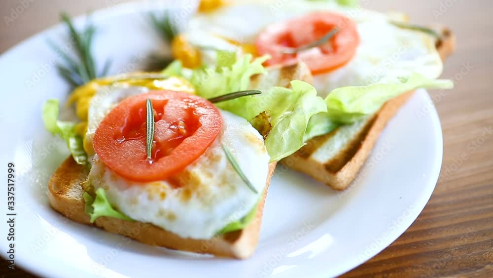 fried toasts with egg, salad, tomato in a plate fried toasts with egg, salad, tomato in a plate