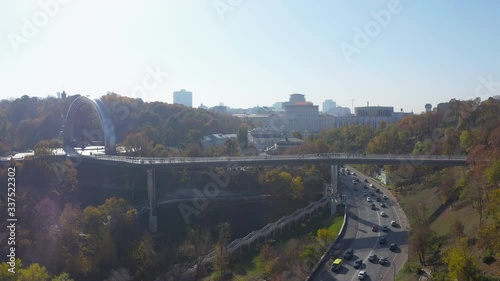 people walk carefree - Pedestrian-bicycle bridge over Vladimirsky descent and Peoples' Friendship Arch, Khreshchatyi park photo