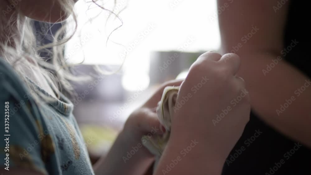 Mother and daughter work together on homemade face masks Mother and daughter work together on homemade face masks