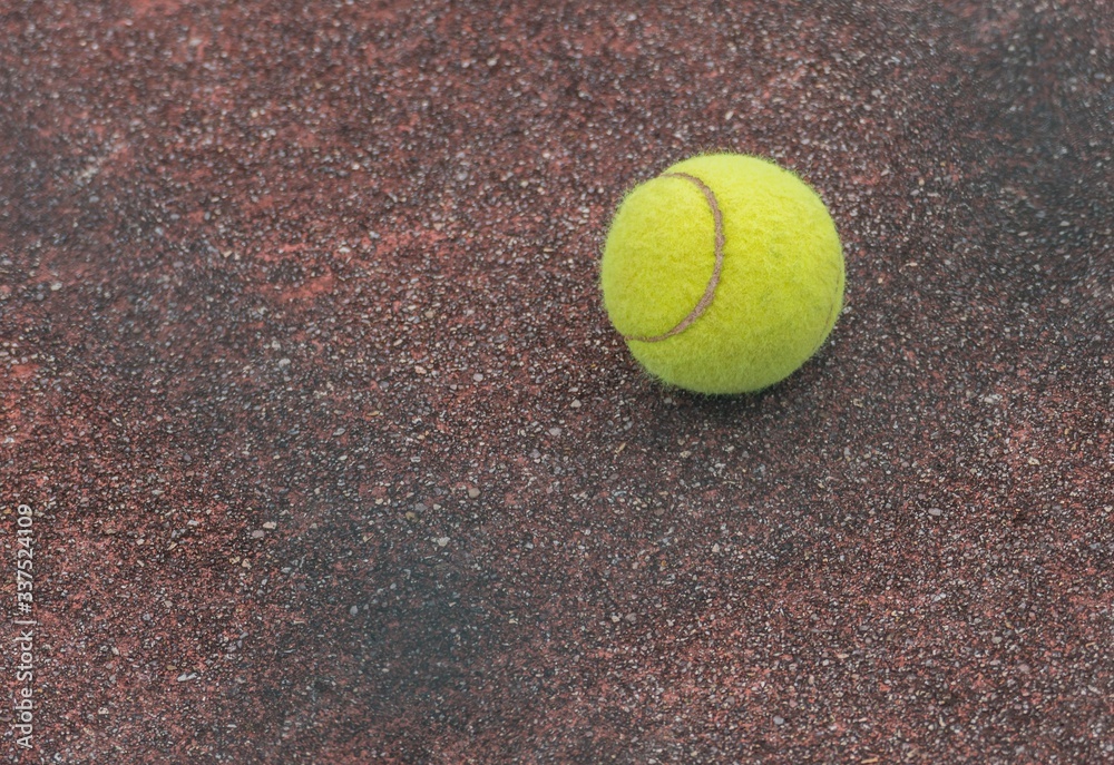 tennis ball on asphalt ground