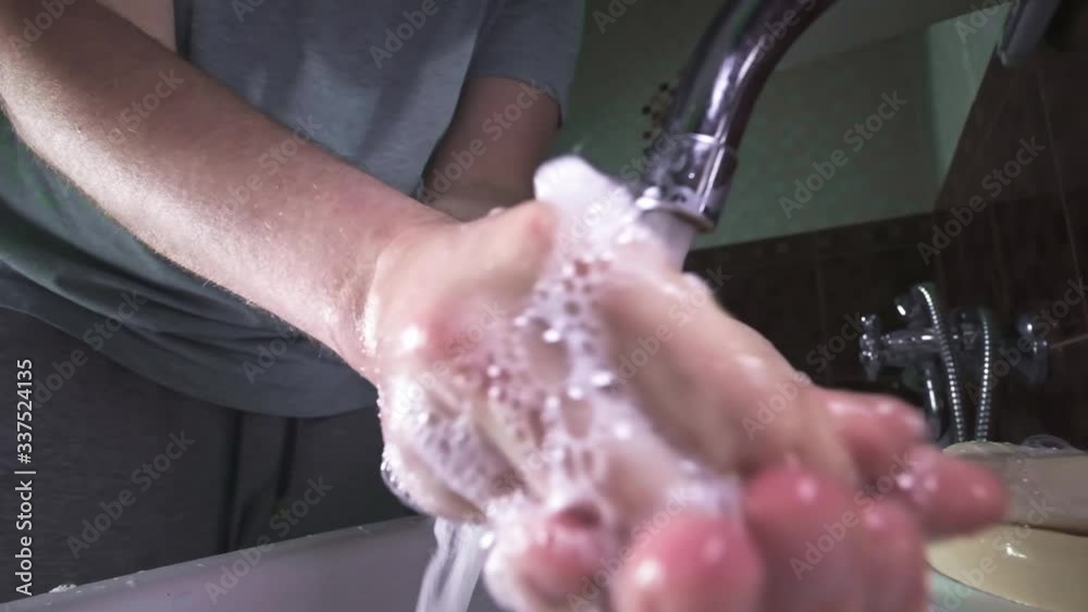 Man washing hands the best way at home coronavirus rinse water rub soap dry towel close up. MERS-Cov, SARS-cov-2 pandemic. Wash your hands regularly with soap and water. Stop spreading viruses Man washing hands the best way at home coronavirus rinse water rub soap dry towel close up. MERS-Cov, SARS-cov-2 pandemic. Wash your hands regularly with soap and water. Stop spreading viruses