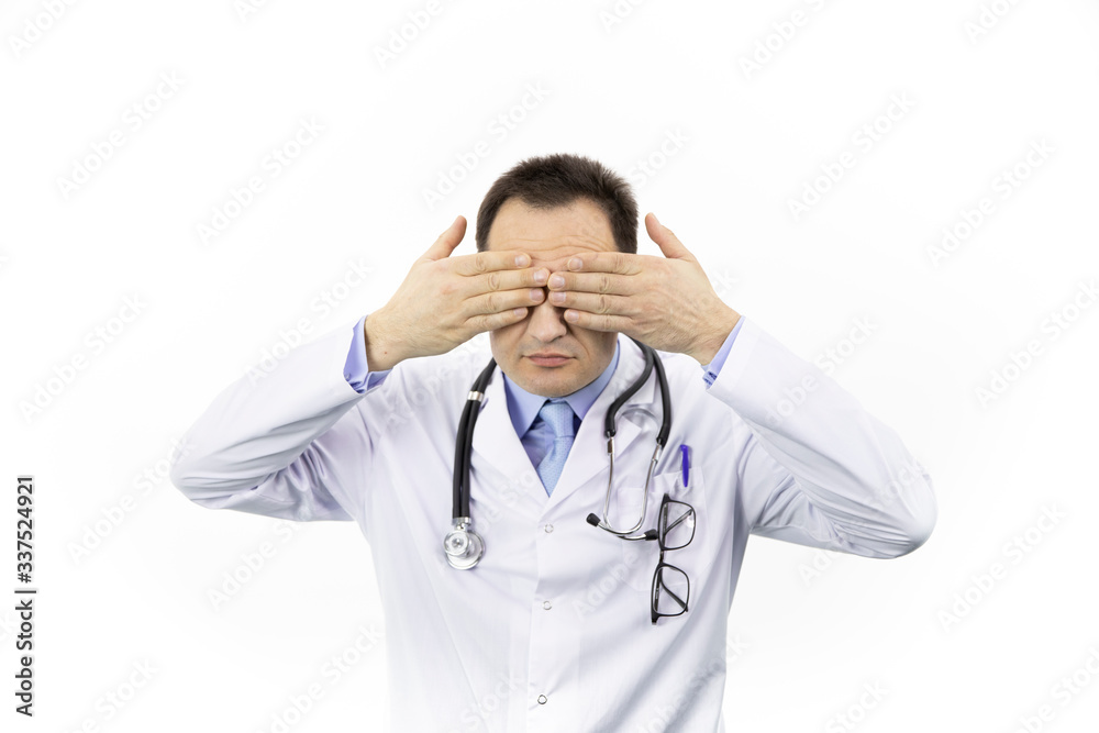 Middle aged handsome doctor in white coat and stethoscope closes eyes with hands, isolated white background, blind, i see nothing, medicine, profession, people concept Middle aged handsome doctor in white coat and stethoscope closes eyes with hands, isolated white background, blind, i see nothing, medicine, profession, people concept