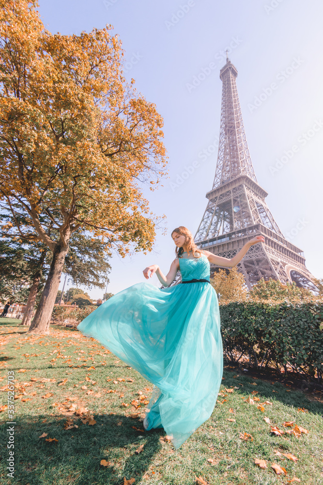 Beautiful young woman near the Eiffel tower in Paris