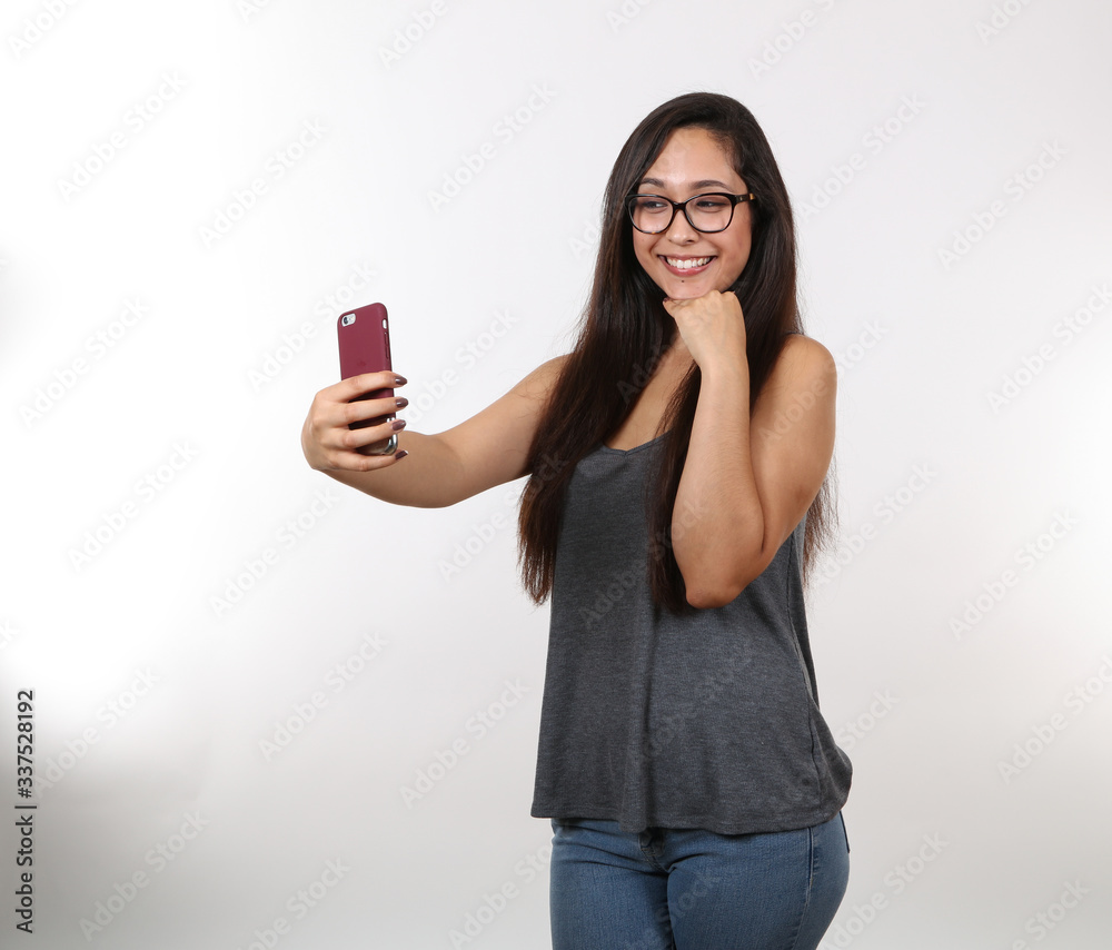 An Attractive Young Girl Takes A Selfie On Phone An Attractive Young Girl Takes A Selfie On Phone