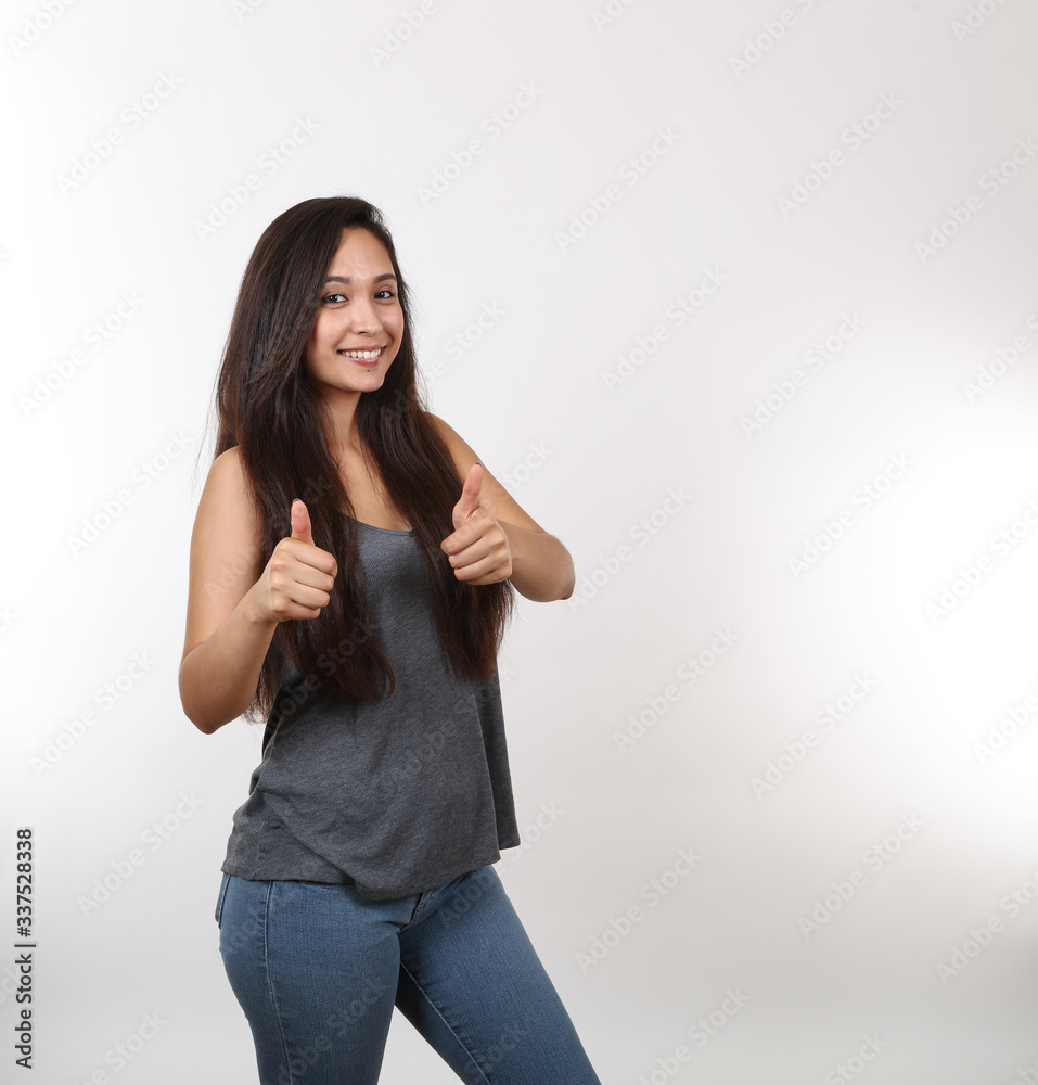 Young Girl Wearing Jeans Gives Two Thumbs Up Young Girl Wearing Jeans Gives Two Thumbs Up