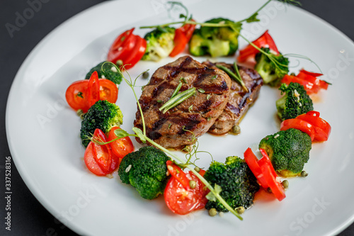 grilled meat with tomatoes and broccoli