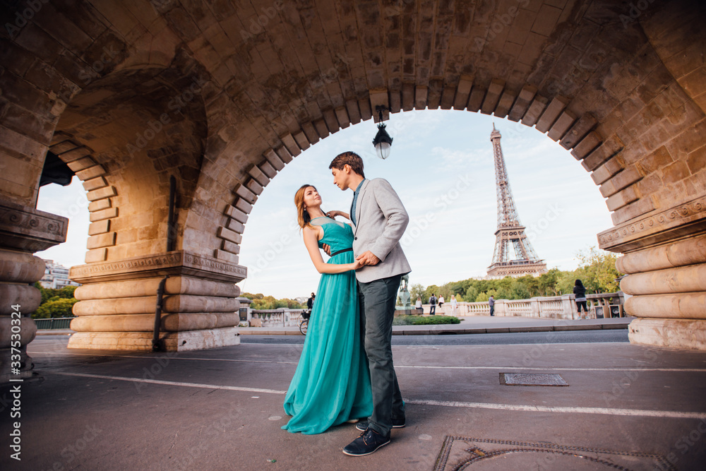 A romantic couple of lovers meet near the Eiffel tower.Paris, France A romantic couple of lovers meet near the Eiffel tower.Paris, France