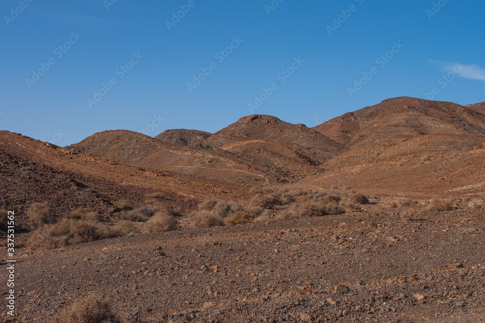 panorama of mountains overlooking the sea in the desert on the Atlantic coast of the island of Fuerteventura. Las Playitas, october 2019