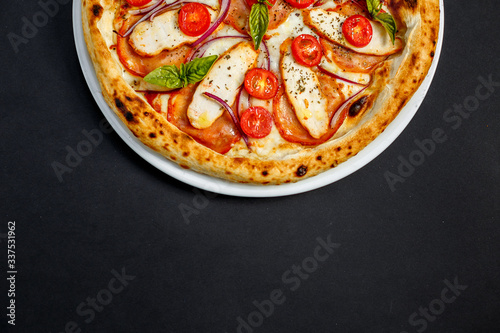 pizza with cheese and chicken with tomatoes