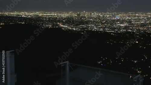 AERIAL: Spectacular Flight over Letter O of Hollywood Sign at Night with Los Angeles City Lights 