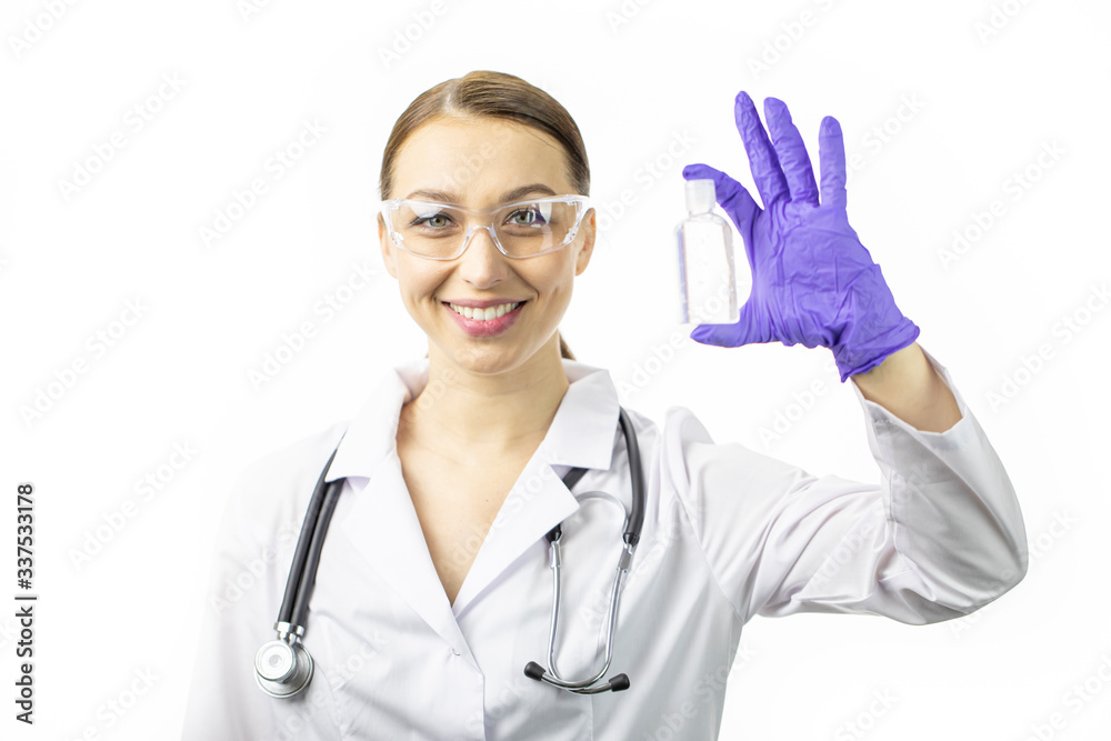 Beautiful smart sexy female doctor in white medical coat and stethoscope holding sanitizer alcohol gel dispenser in hand to prevent spread of bacteria and virus. Care, distancing, protection concept Beautiful smart sexy female doctor in white medical coat and stethoscope holding sanitizer alcohol gel dispenser in hand to prevent spread of bacteria and virus. Care, distancing, protection concept